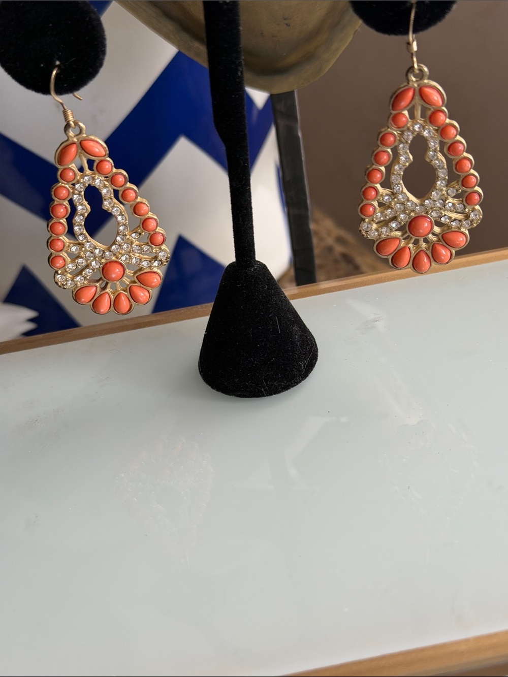 Coral colored cabochons with sparkling crystals lace like design set in oval
